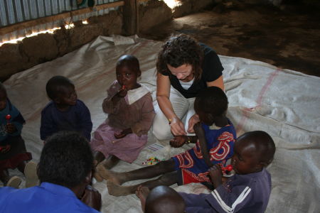 Jennifer helps some children make bracelets