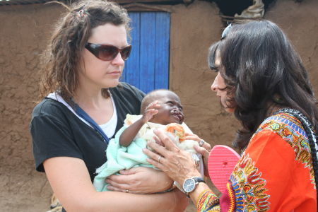 Jennifer and Molly hold a malnourished little girl with a cleft pallet