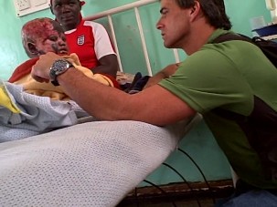 Joe talks with a toddler in the burn ward