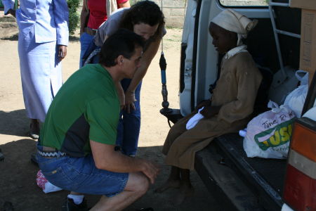 Jennifer and Joe fit a girl with new shoes