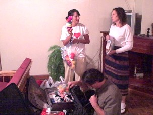 Molly, Joe, and Jen going through suitcases of items given.